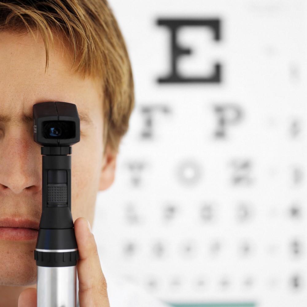 Optometrist using ophthalmoscope
